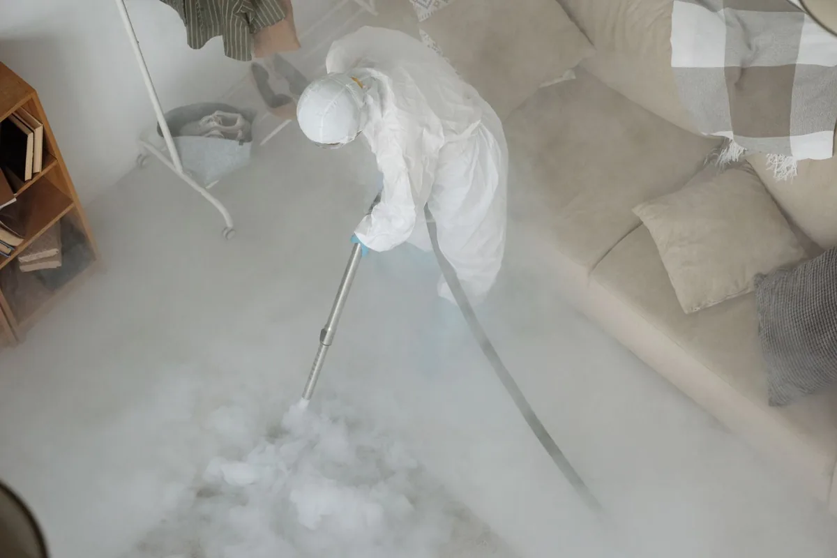 Biohazard cleanup technician in protective equipment, Cadillac Heights, Detroit, MI